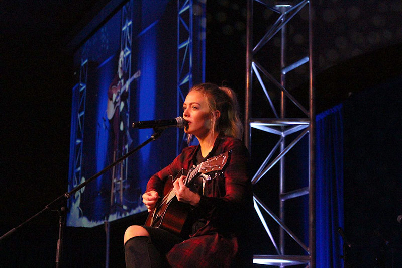 A student is performing guitar