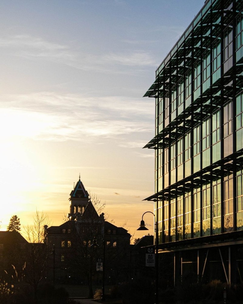 The sun sets behind Old Main on a weekday evening