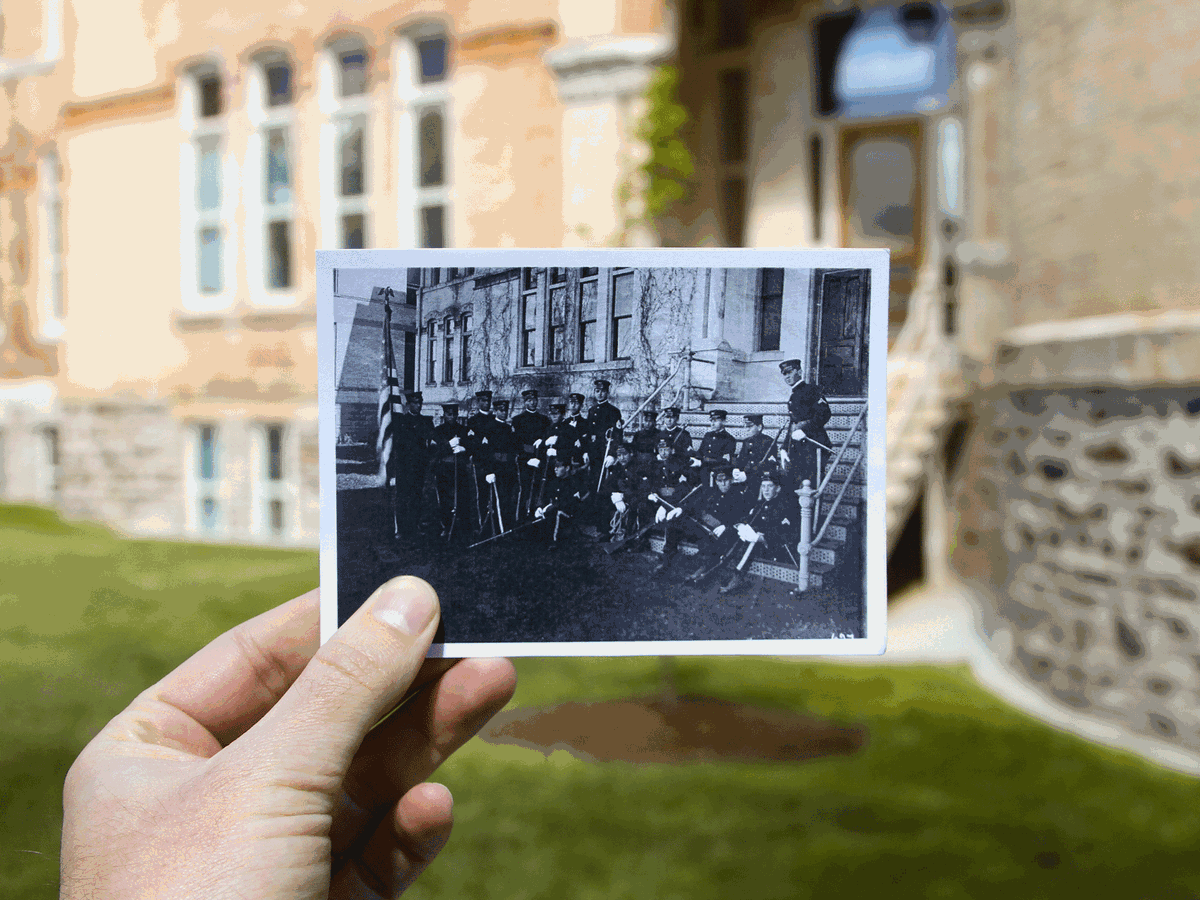 Members of USU's ROTC (circa 1920) sitting on the steps leading to the south wing of Old Main.