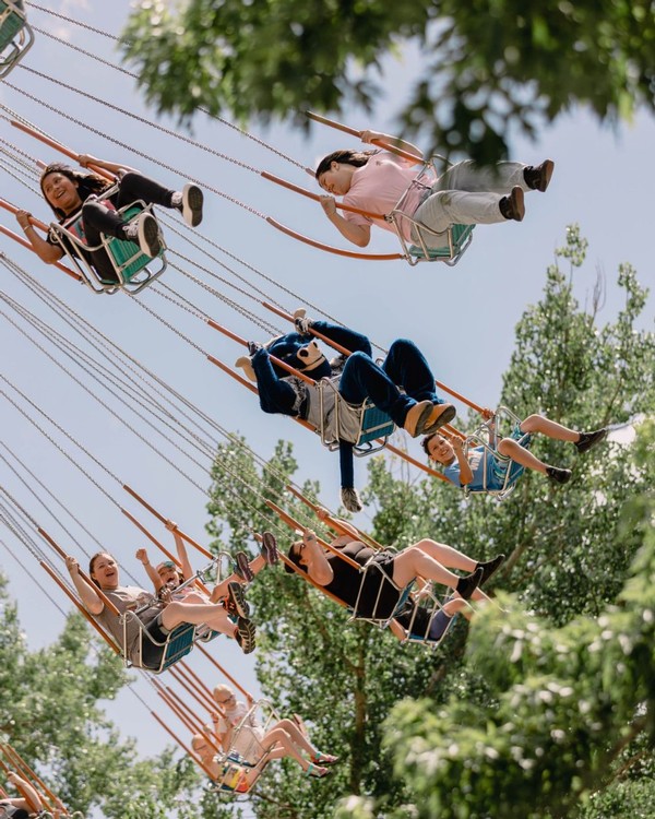 Big Blue rides the swings at Lagoon amusement park.