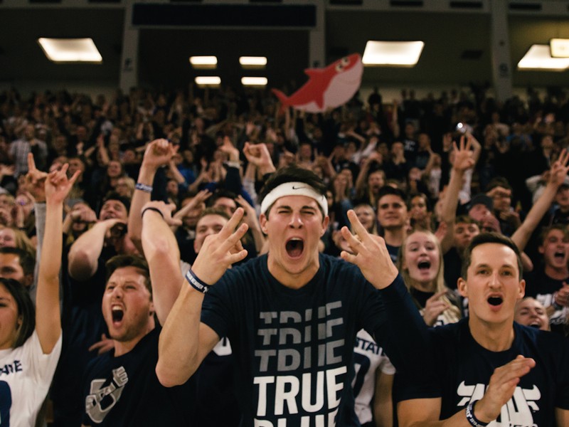 Students cheer in the basketball student section.