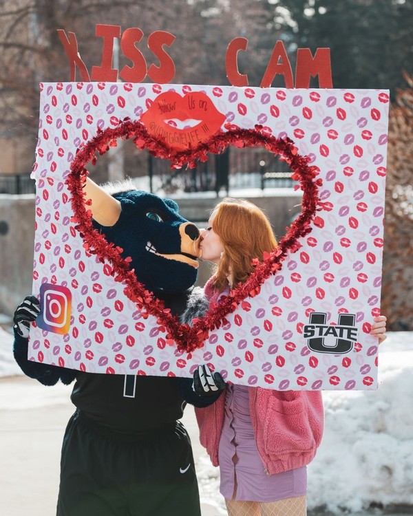 Big Blue gets a kiss from a female student in front of a