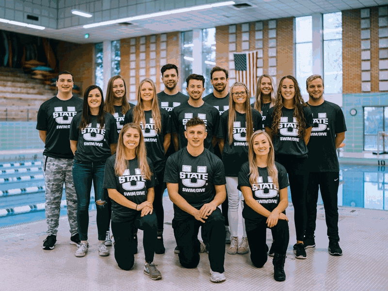 USU Swim and Dive Club members posing by the pool for a group picture.