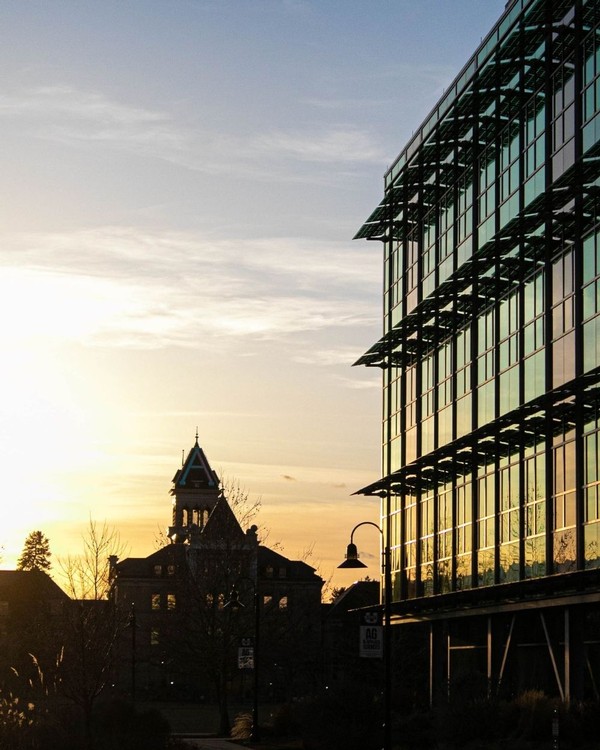 The sun sets behind Old Main on a weekday evening