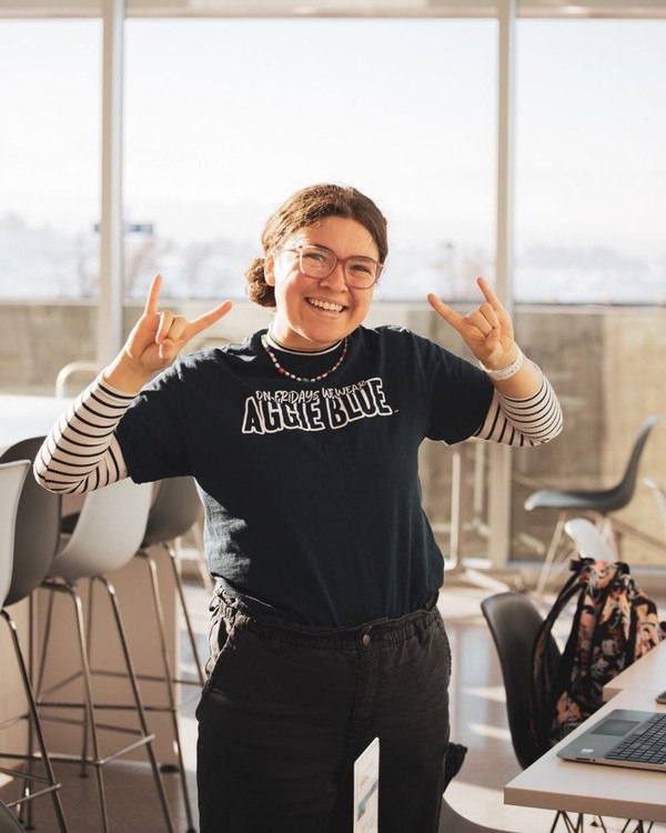 A female USU student poses for a photo with her 