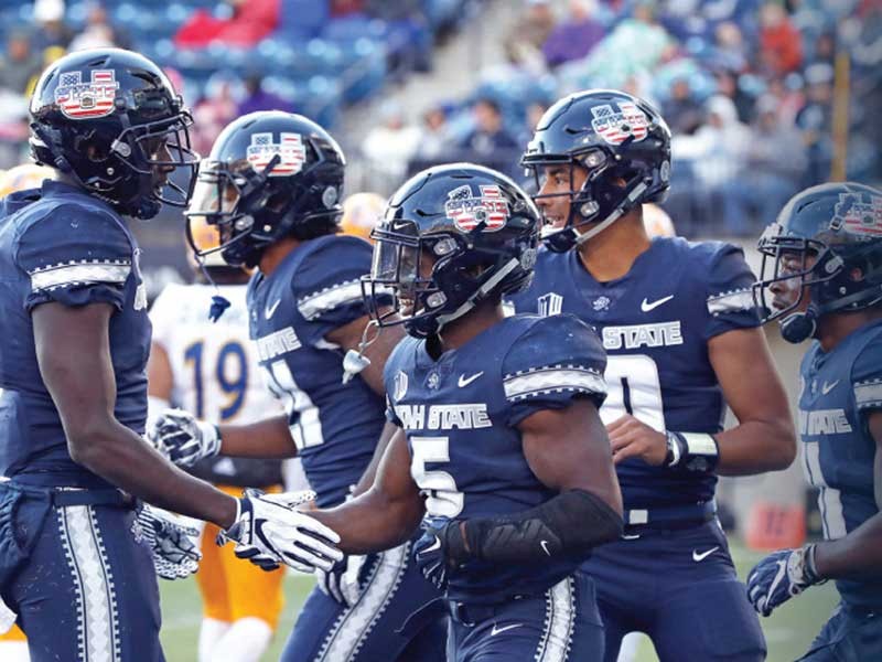 Aggie football players on the field