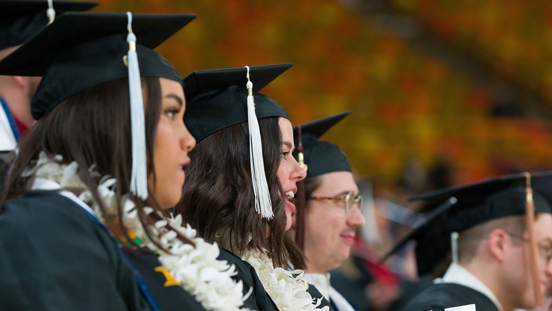 Students applaud during a previous USU commencement ceremony in the Spectrum.