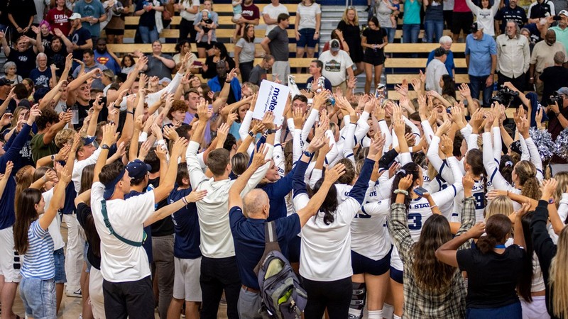 USU Volleyball players and staff celebrate during a match.