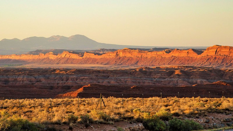 A landscape shows rugged desert cliffs and mountains.