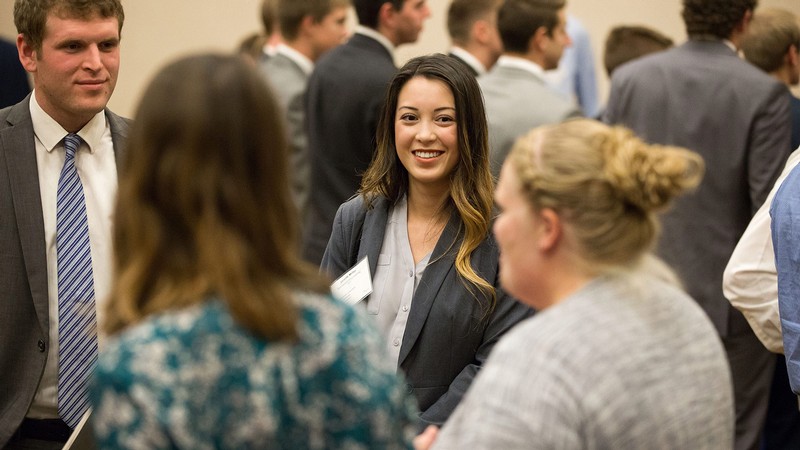 People talk at a professional networking event.