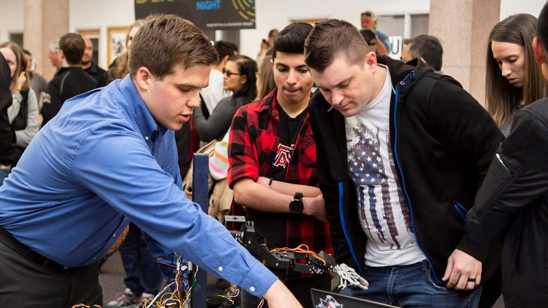 A student demonstrates an engineering design project in the Taggart Student Center.