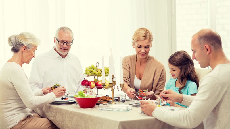 People eating a meal around a table.