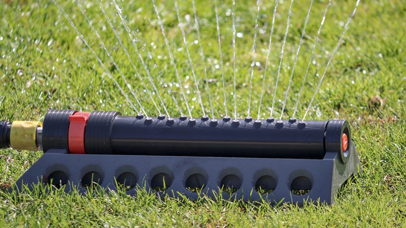 A sprinkler waters a lawn.