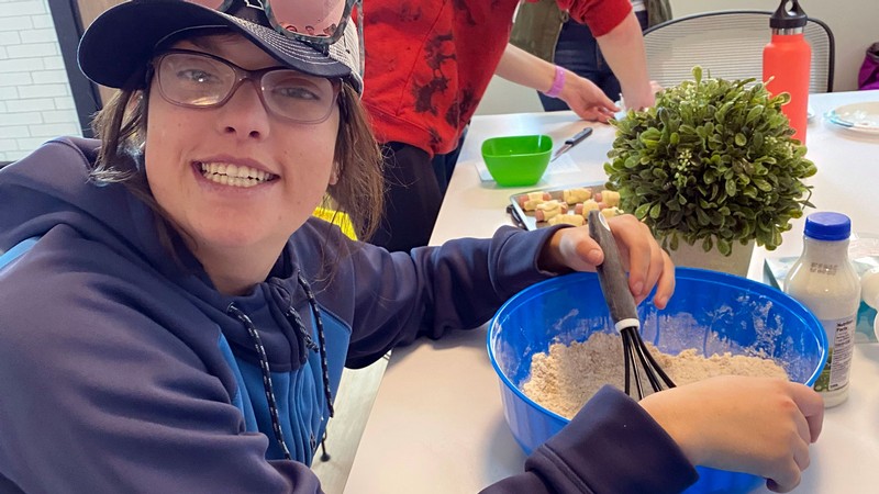 A person whisks ingredients in a bowl.