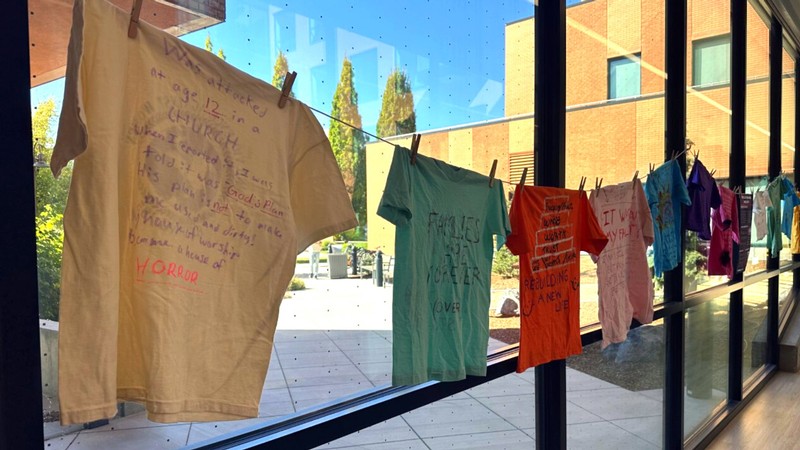 T-shirts bearing handwritten messages about domestic violence.