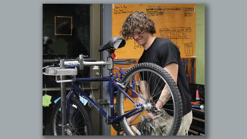 A mechanic working on a bike.
