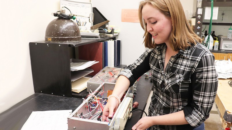 Heather Allen works in a USU Physics lab.
