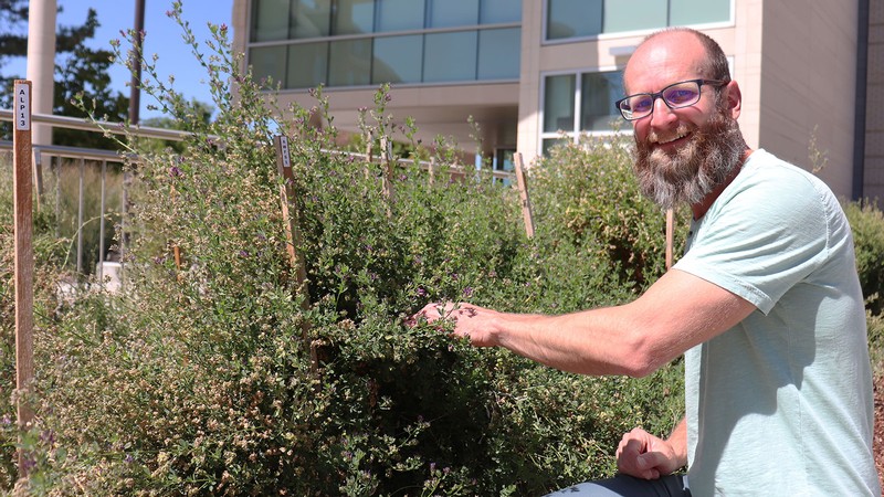 Researcher in garden.