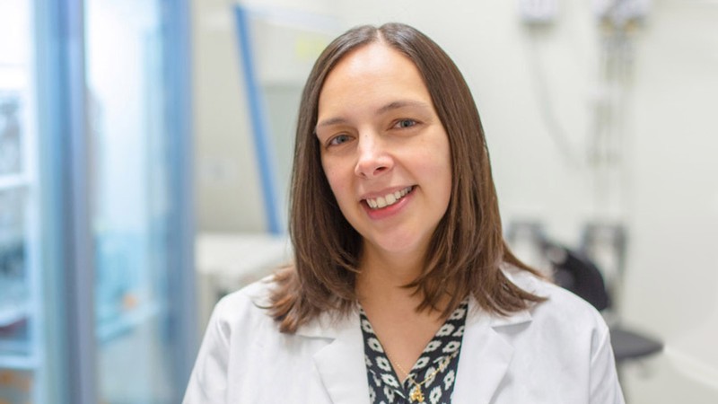 Sheena D'Arcy wearing a lab coat.