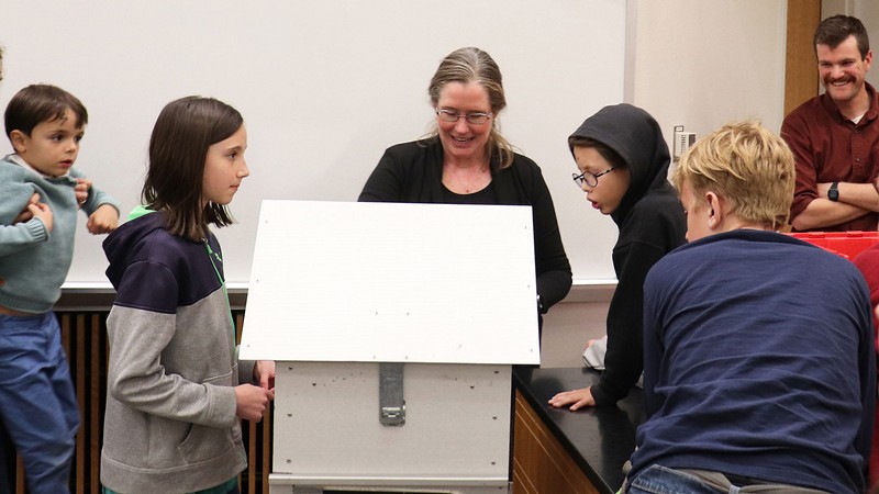 Group observing field research equipment.