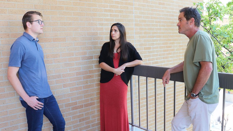 Zachary Zito speaks with Brittany Gentry and Charlie Torre in an outdoor space at USU.