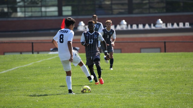 Men play soccer.