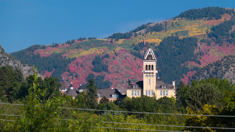 Old Main against fall colors on the hillside.