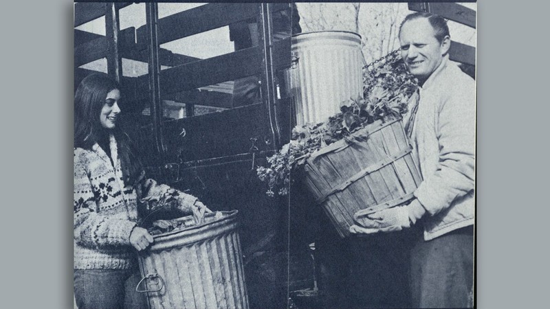 Val R. Christensen and a woman carring leaves in this black-and-white photo.