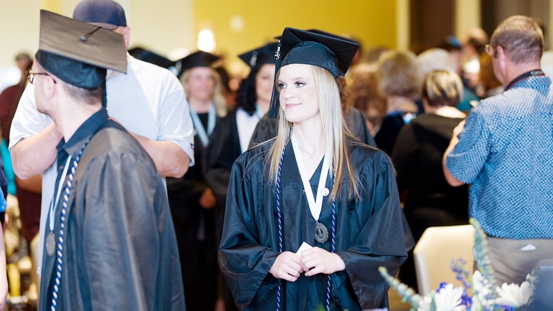 A female graduate approaches the graduation stage