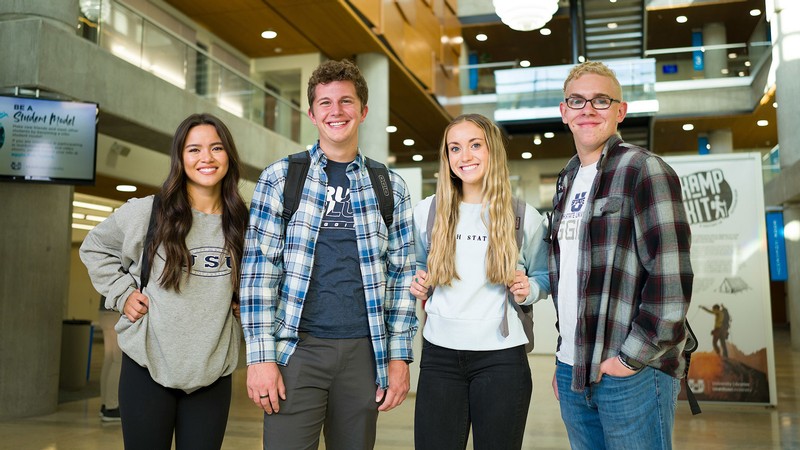 Students standing in a USU library.