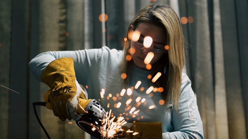 A person uses a welding tool
