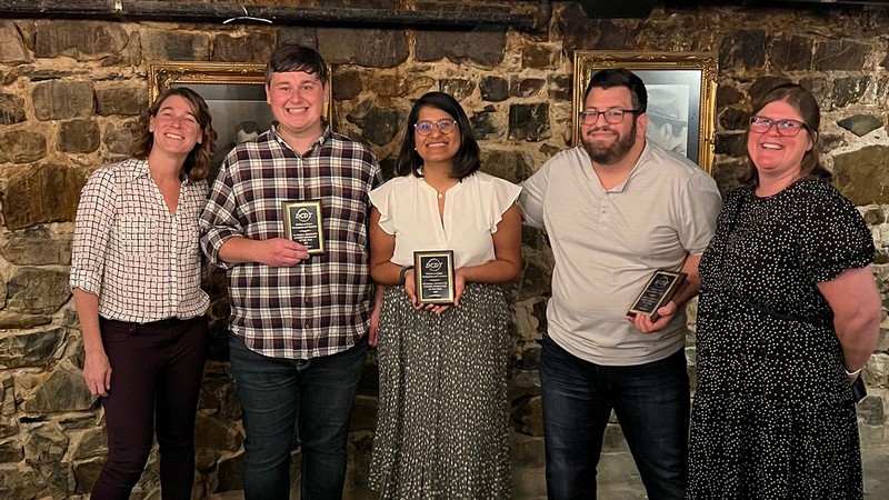 People with award plaques.