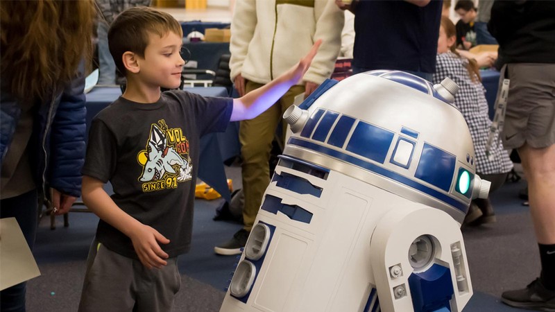A boy and a robot.