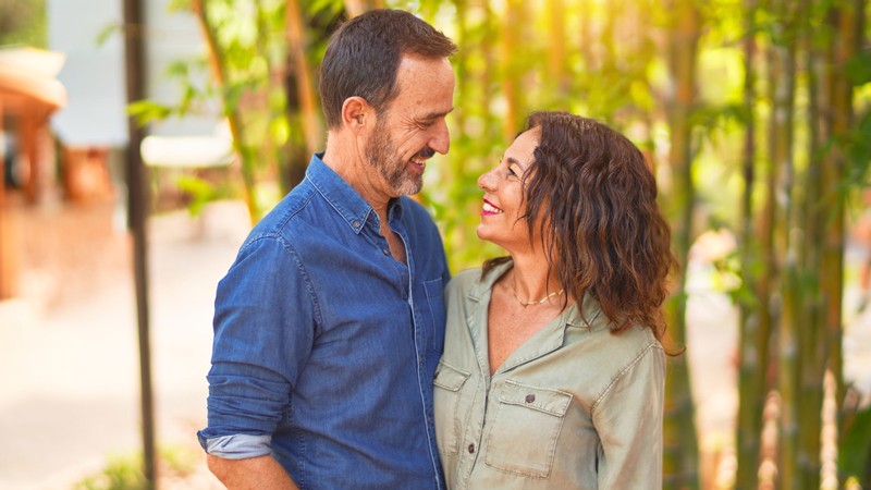 A couple smiling and looking at each other.