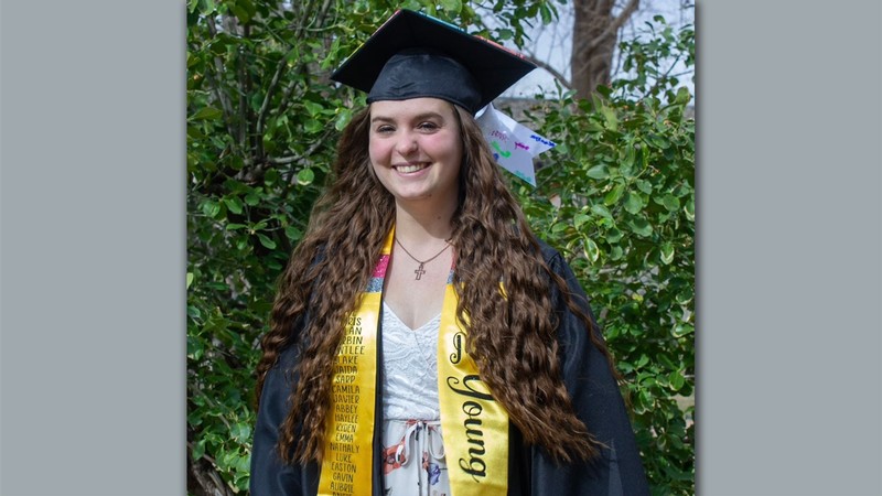 Kaylan Young in graduation cap and gown.