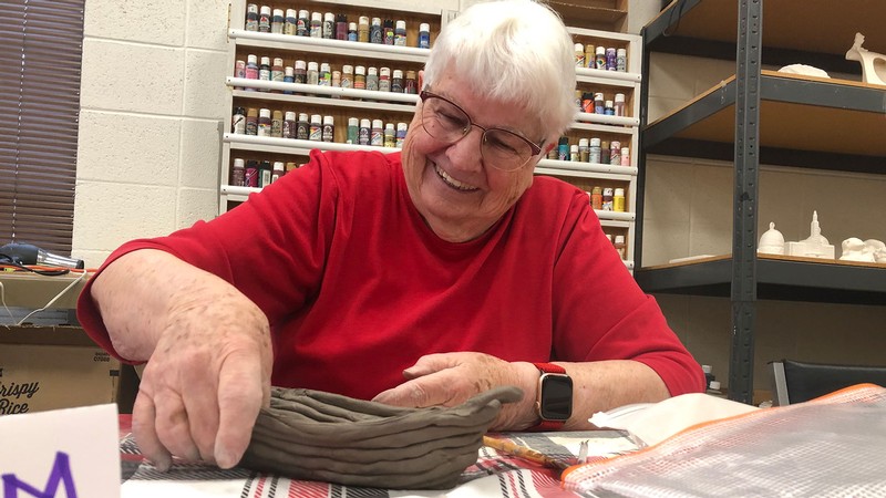 A person making a clay pot.