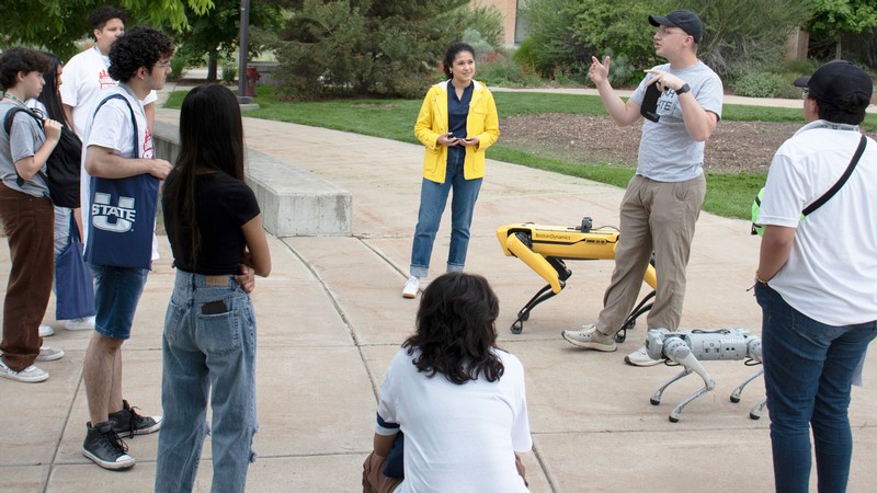 People with robotic dogs.