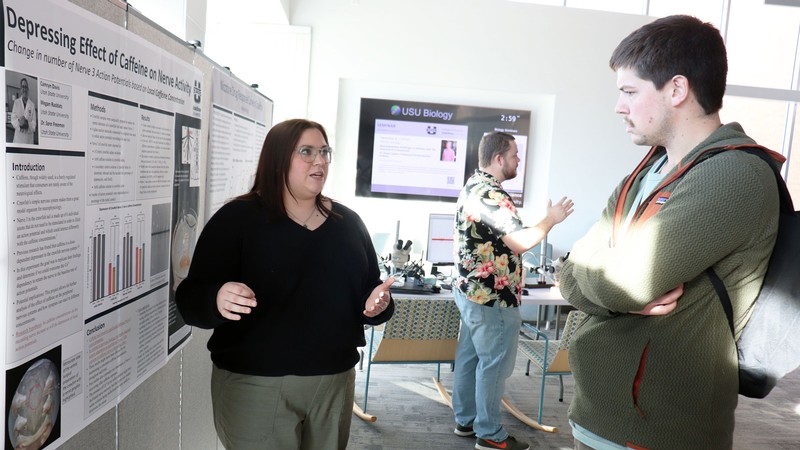 Students at research poster session.
