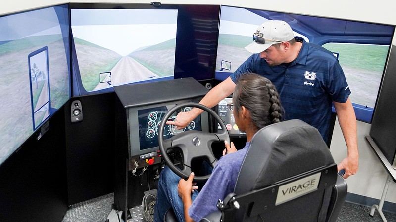 People using a truck simulator.