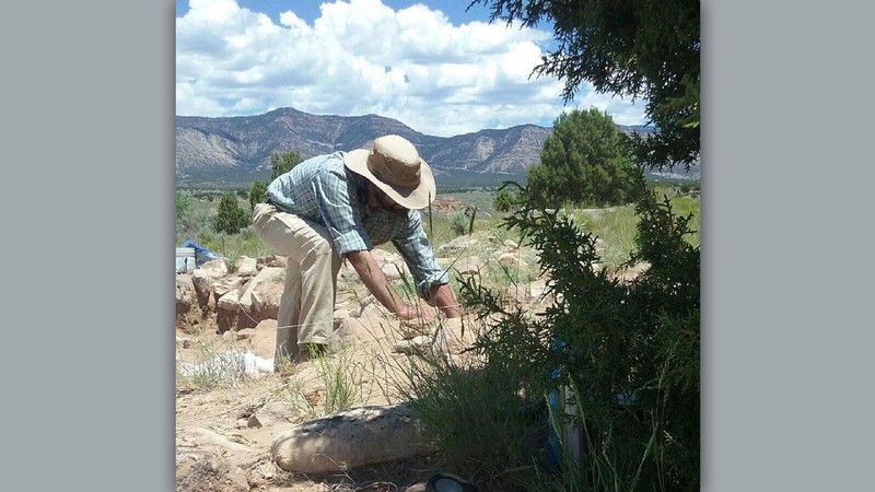 An archaeologist works in the ground.