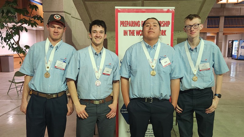 Four students pose for a photo