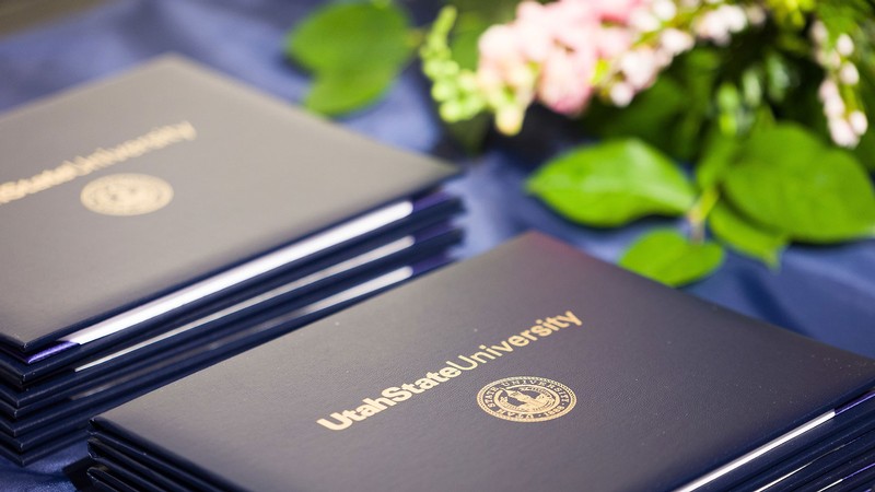 Utah State University diploma covers.