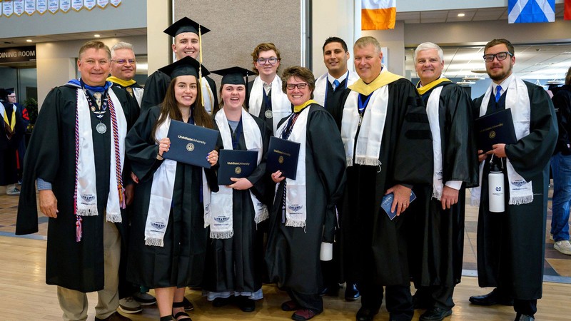 People in graduation robes.
