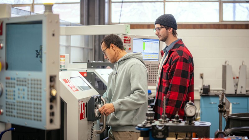People using manufacturing equipment.