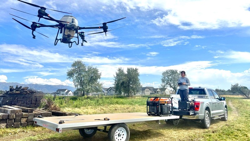 Rachel Reeder controlling a drone at a farm.