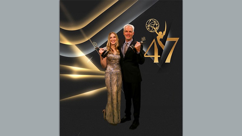 Erin Cox and Brian Champagne posing with their regional Emmy awards.