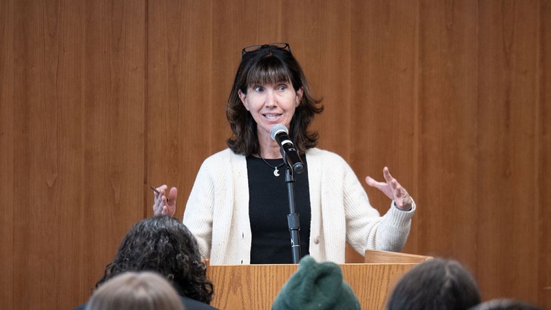 Jennifor Sinor speaking at a rostrum.