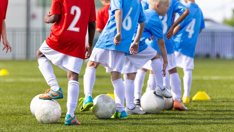 Kids playing soccer.