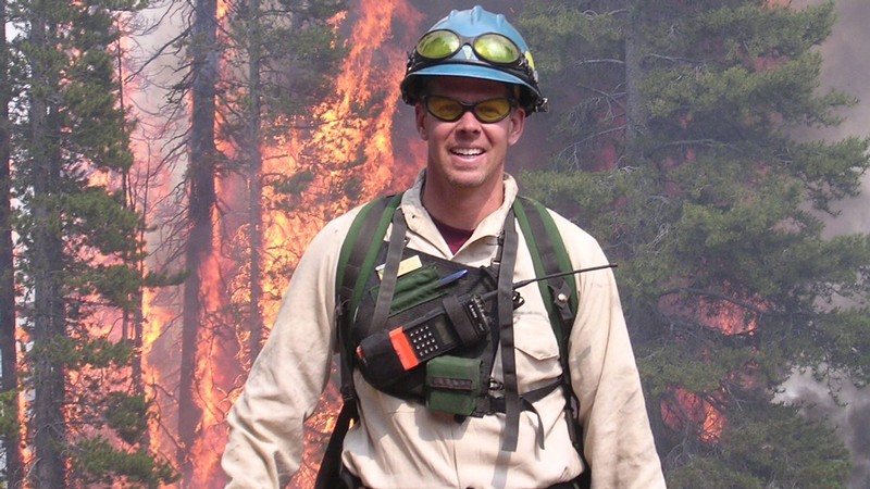 Brad Washa in front of a wildfire.