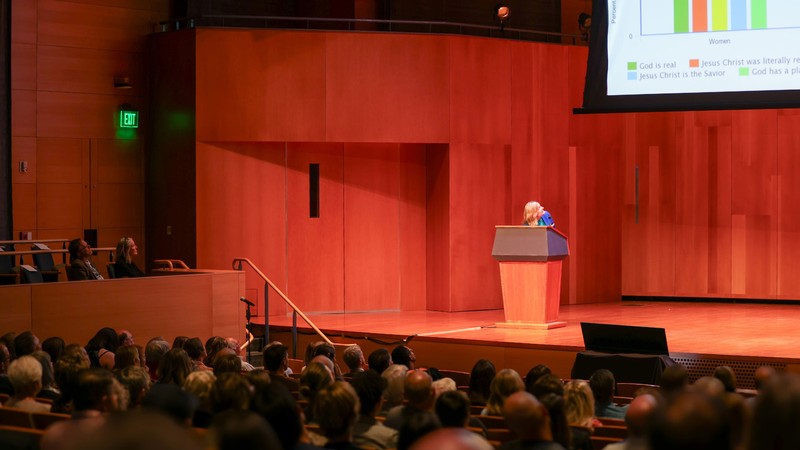 Jana Riess giving a lecture at a rostrum.